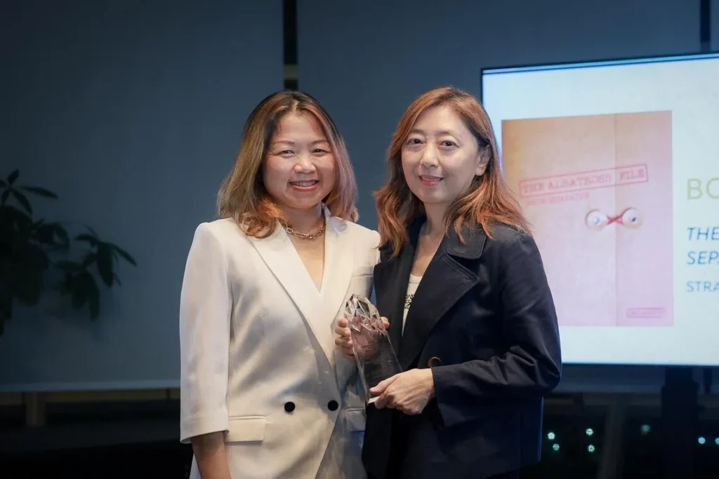 The Straits Times chief columnist and senior editor of publications Sumiko Tan receives the Book Of The Year award from NLB CEO Melissa Tam (left, white top) at the Singapore Book Awards.