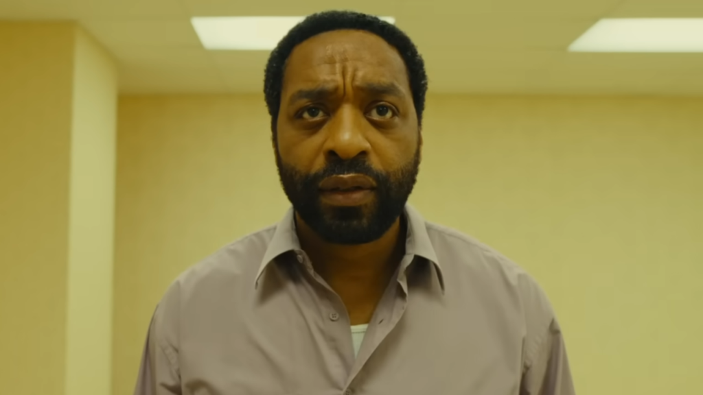 Backrooms protagonist looking at camera incredulously with the titular backrooms visible in background