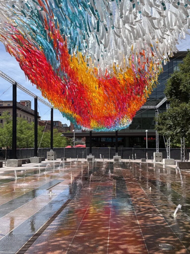 Colorful floating sculpture flying high over Denver Union Station