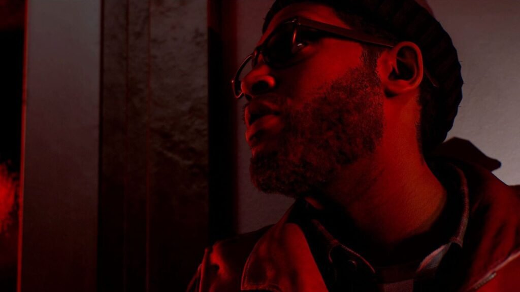 A man stands in dull red light